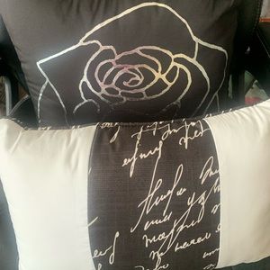 Two decorative throw pillows in black white and silver